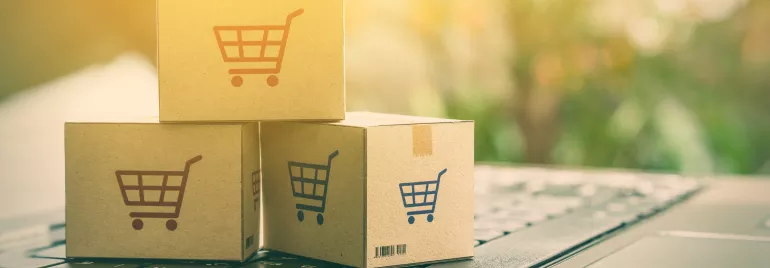 Cajas de cartón con símbolo de carrito sobre un teclado.